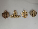 four different types of badges are shown on a white surface