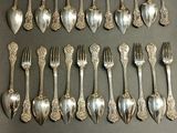 a lot of silver spoons and forks on the table