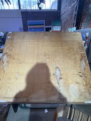 a shadow of a person sitting at a table