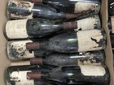 many bottles of wine in a box on the floor