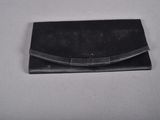 black leather purse with a metal clasp on a white surface