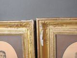 pair of framed portraits of a man and a woman