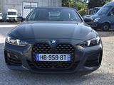the front view of a black bmw car parked in a parking lot