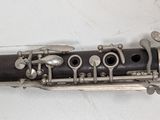 a close up of a clarinet on a white surface