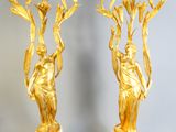 two gold colored vases sitting on a marble table