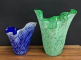 two vases that are sitting on a wooden table
