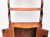 an old wooden bookcase with two open doors on top of it