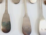 six spoons that have the names of different people on them