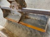 a large piece of metal sitting on top of a wooden bench