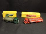 three toy trucks are sitting next to each other on a black surface