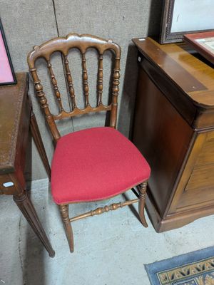 a chair that is next to a table with a mirror on it