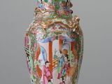 a vase that is sitting on a table with a lid