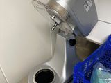 a silver mixer sitting next to a blue crate
