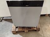 a white dishwasher sitting on a pallet in a room