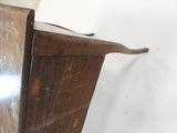 a wooden cabinet with writing on the side of it