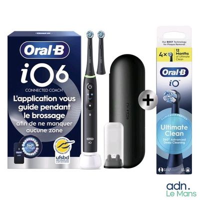 une brosse à dents posée à côté d'un tube de dentifrice