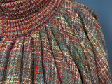 a close up of a mannequin wearing a multicolored dress