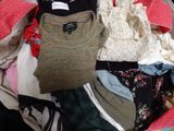a suitcase full of clothes and clothes on the floor