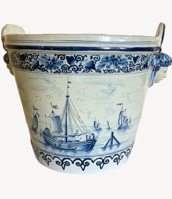 a large blue and white vase with a boat on it
