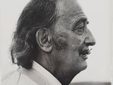 an old black and white photo of a man with long hair