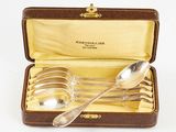 four spoons and two spoons in a case