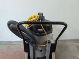 a vacuum that is sitting on the floor next to a wall