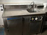 a kitchen with a sink and a stove in it