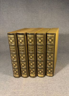 a set of five books sitting on top of each other on a table