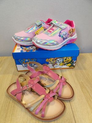 a close up of a pair of pink shoes on a table