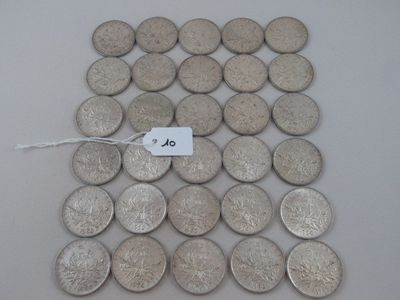 some silver coins are on a white surface with a price tag