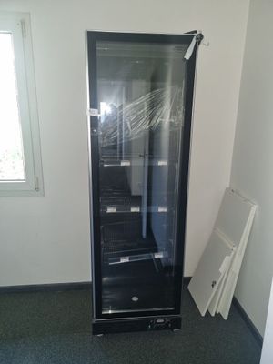 a black refrigerator in the corner of a room