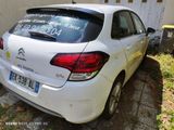 a white car that is parked in front of a building