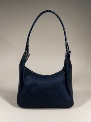 a black guccissi bag with a gold buckle on the handle