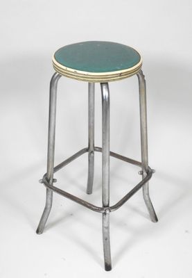 an image of a metal stool with a green seat on a white background
