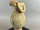 an image of a stone statue of a sheep on a black base