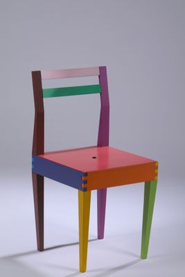 a colorful chair that is sitting on a white surface