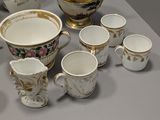 many different types of tea cups and saucers on the table