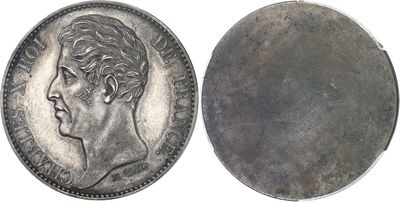 a close up of a coin with a man ' s face on it