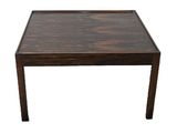 the table is made of wood and has a square top