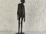 a small statue of a man standing on a base