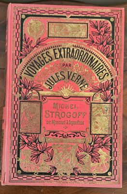 a pink book sitting on top of a wooden table