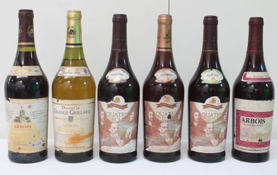several bottles of wine are lined up in a row on a table