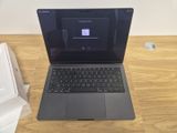 an open laptop computer sitting on top of a wooden table
