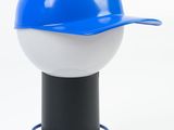a blue and white baseball cap on top of a lamp
