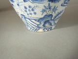 a blue and white vase sitting on a table