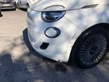 a white smart car parked on the side of the road