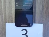 an image of a cell phone sitting on top of a wooden table