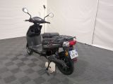 a scooter parked in a room with a checkered floor