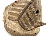 a wooden object that is sitting on a white surface