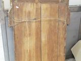 an old wooden cabinet with a mirror on top of it